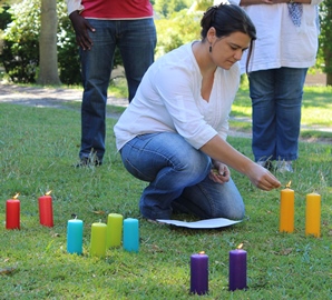 Juanita leading a candle prayer at FLEAT workshop - web -copy